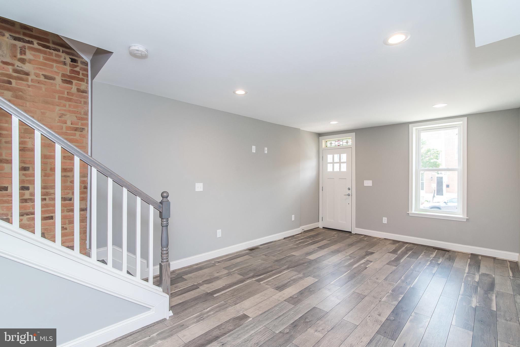 704 East Fort Avenue Baltimore, MD 21230 - Photo 29 of 58 a view of an empty room with wooden floor and a window