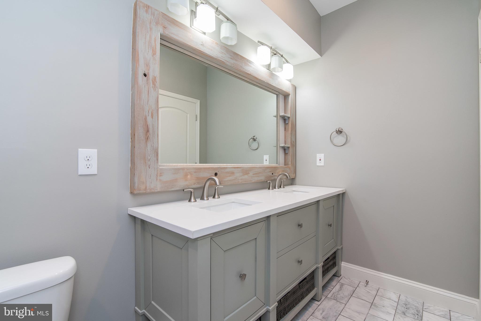 704 East Fort Avenue Baltimore, MD 21230 - Photo 31 of 58 a bathroom with a sink a toilet and a mirror