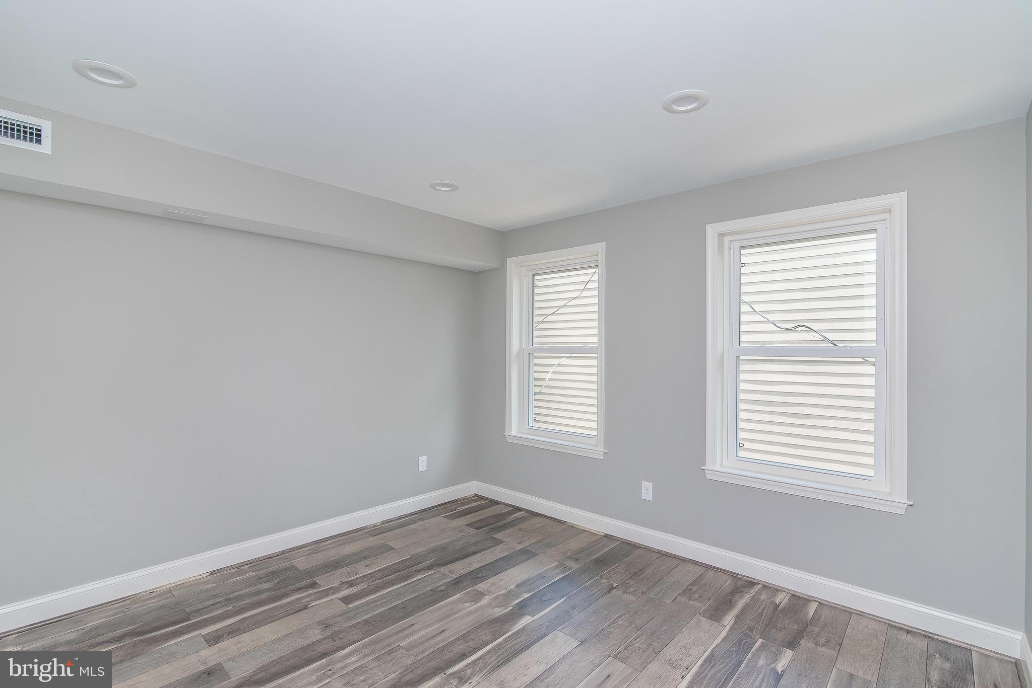 704 East Fort Avenue Baltimore, MD 21230 - Photo 35 of 58 a view of an empty room with wooden floor and a window