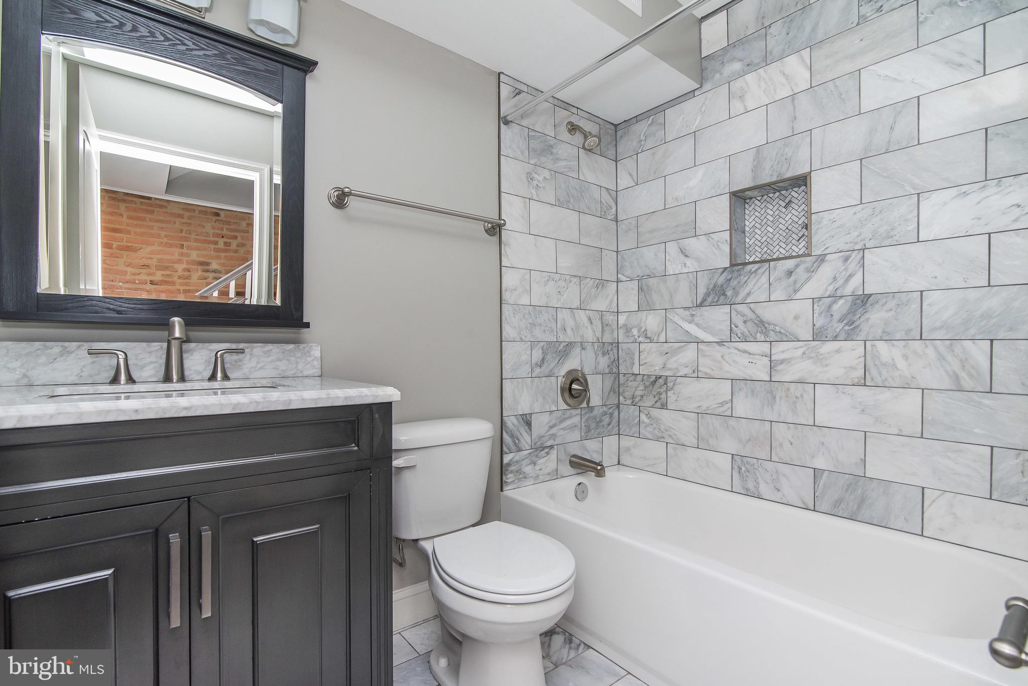 704 East Fort Avenue Baltimore, MD 21230 - Photo 43 of 58 a bathroom with a sink a toilet and a bathtub
