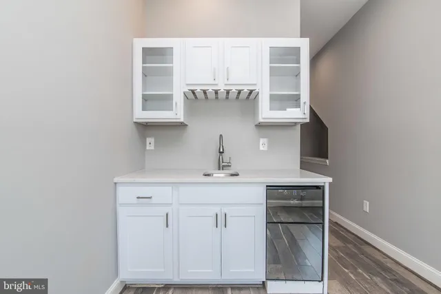 a roof deck with chairs and potted plants