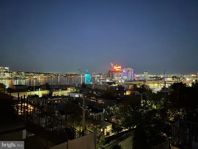 a outdoor dining space with furniture and city view