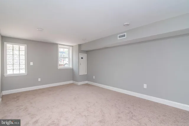 a view of an empty room with windows