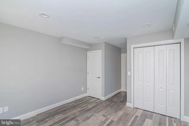 a kitchen with stainless steel appliances a counter top space cabinets and a window