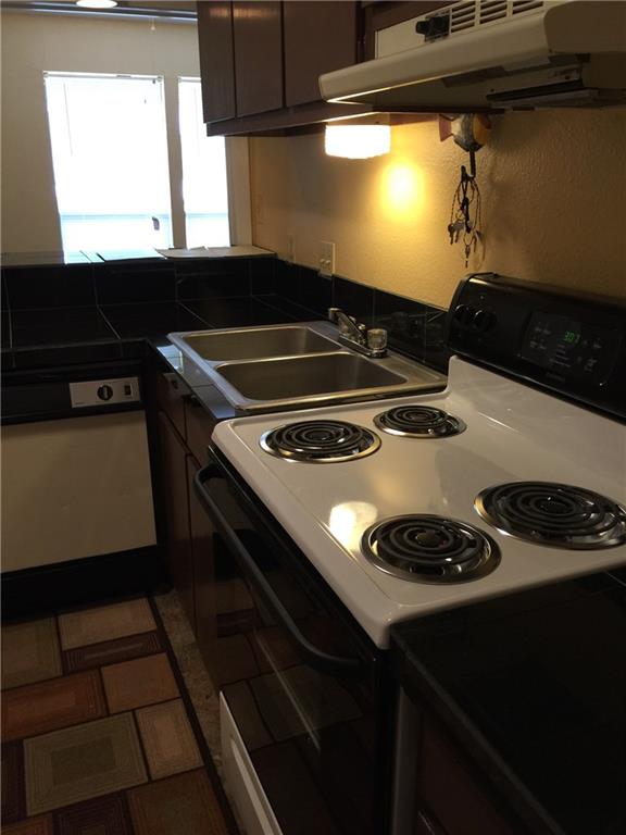 3000 Guadalupe Street, Unit 307 Austin, TX 78705 - Photo 17 of 21 a kitchen with a stove and a microwave