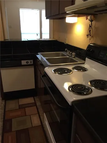 a stove top oven sitting inside of a kitchen