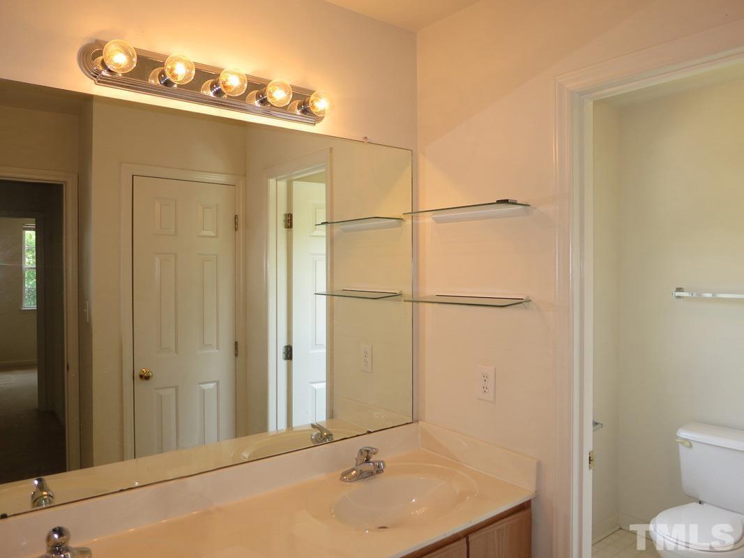 101 Rock Haven Road, Unit D402 Carrboro, NC 27510 - Photo 11 of 14 a bathroom with a sink and a mirror