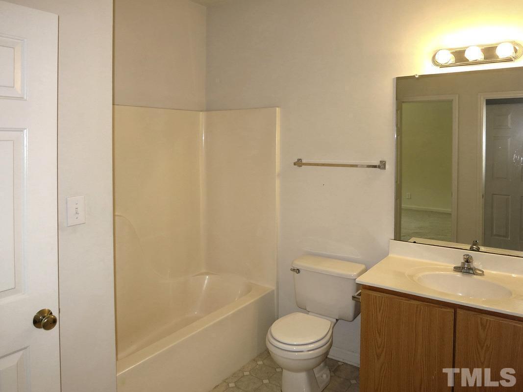 101 Rock Haven Road, Unit D402 Carrboro, NC 27510 - Photo 7 of 14 a bathroom with a granite countertop sink toilet and shower