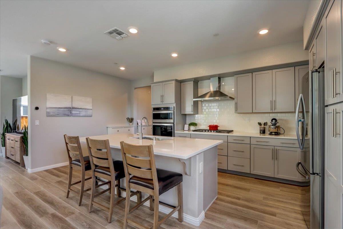 2652 Admiral Circle Hayward, CA 94545 - Photo 13 of 51 a kitchen with stainless steel appliances a sink a stove a refrigerator cabinets and dining table