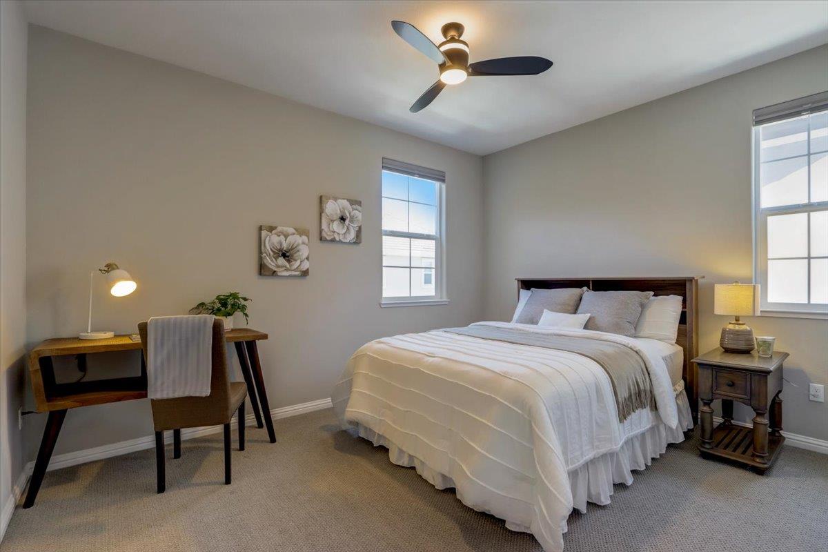 2652 Admiral Circle Hayward, CA 94545 - Photo 29 of 51 a bedroom with a bed a chair and a chandelier