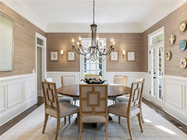 a living room with furniture a rug and a bookshelf