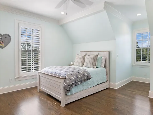 a bed sitting in a bedroom next to a window