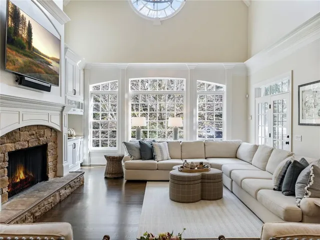 a kitchen with stainless steel appliances granite countertop a table chairs stove and cabinets