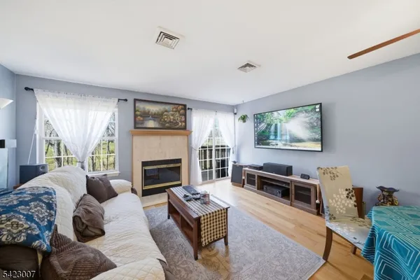 a living room with furniture fireplace and window