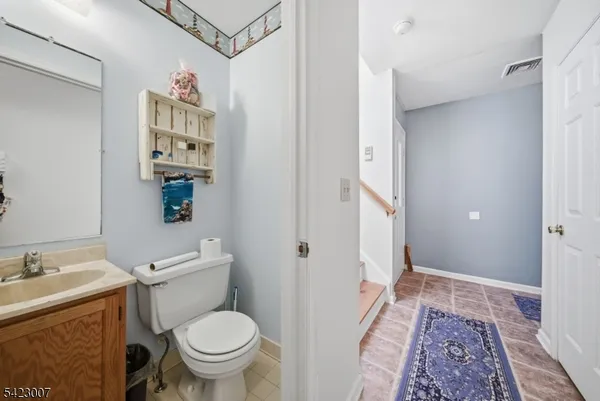 a bathroom with a granite countertop toilet sink and shower