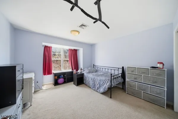 a bedroom with furniture and a window