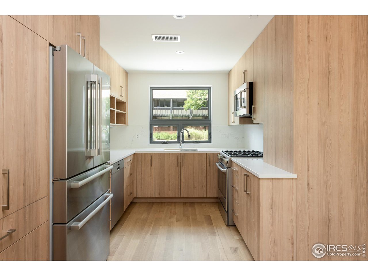 2130 Folsom Street Boulder, CO 80302 - Photo 8 of 40 a kitchen with a refrigerator and a sink