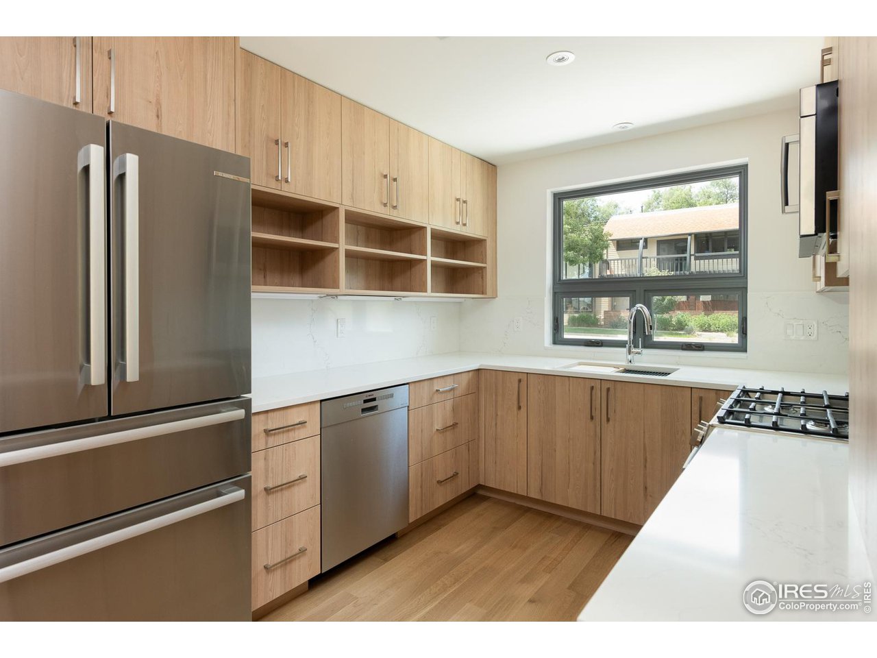 2130 Folsom Street Boulder, CO 80302 - Photo 10 of 40 a kitchen with stainless steel appliances granite countertop a refrigerator and a sink