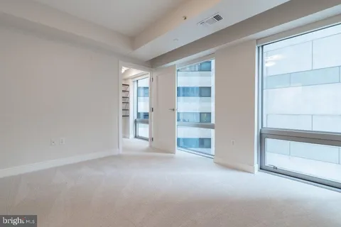 a view of an empty room and closet area
