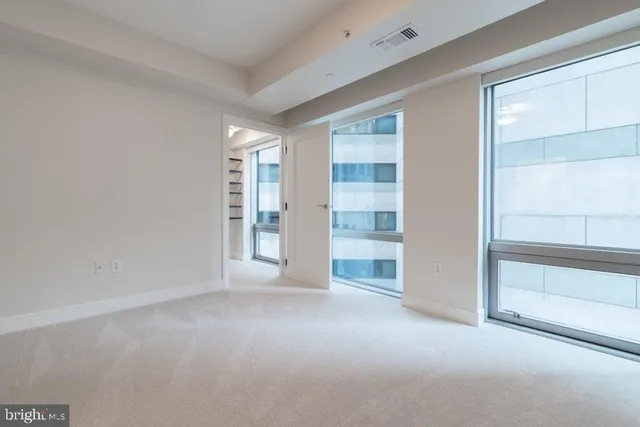 a view of an empty room and closet area