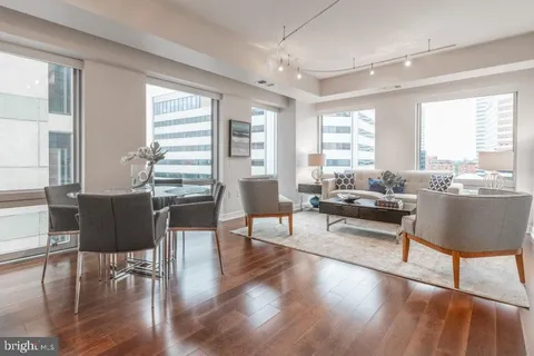 a living room with furniture wooden floor and a table