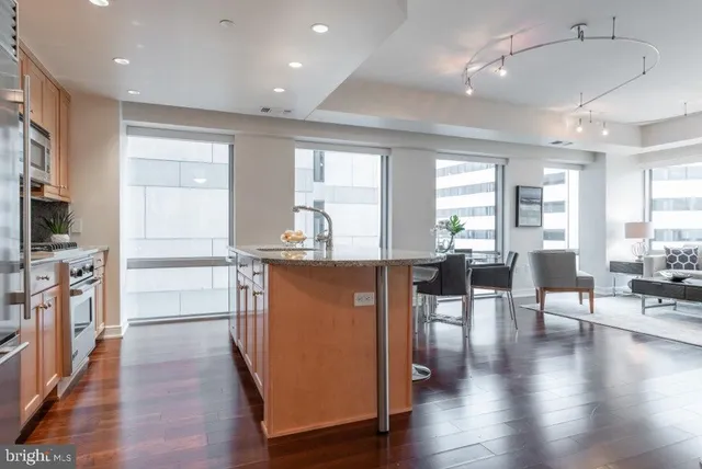 a view of dining room with wooden floor and furniture