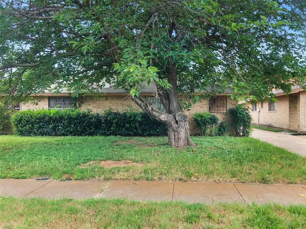 a front view of a house with a yard and a garage