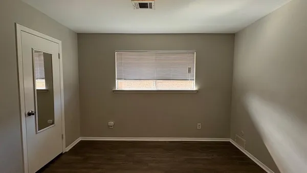 a view of a room with wooden floor