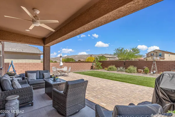 a view of a patio with couches chairs and a yard