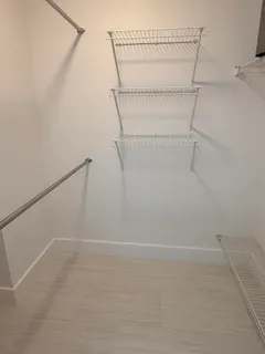 a bedroom with a bed and a chair