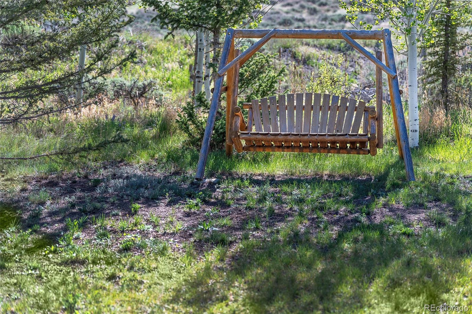 290 Village Road Granby, CO 80446 - Photo 41 of 45 a view of backyard with green space and deck
