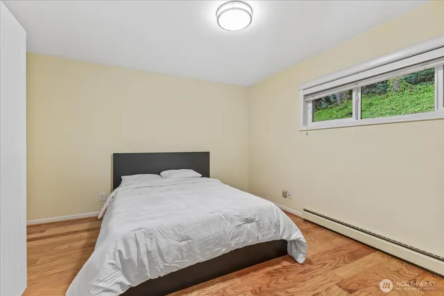 a bedroom with a bed and a window