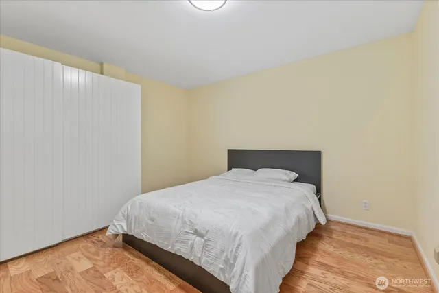 a bedroom with a bed and a night stand