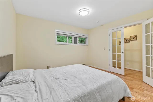 a bedroom with a bed and a window