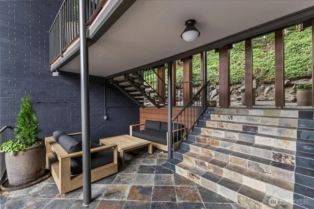a view of entryway with a floor to ceiling window and stairs