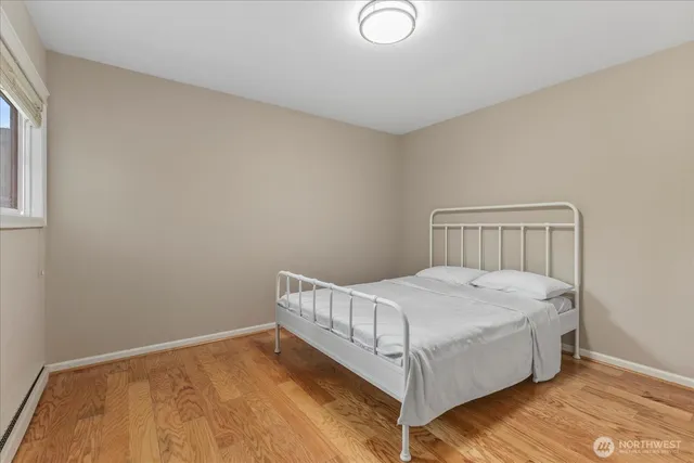 a bedroom with a bed and window