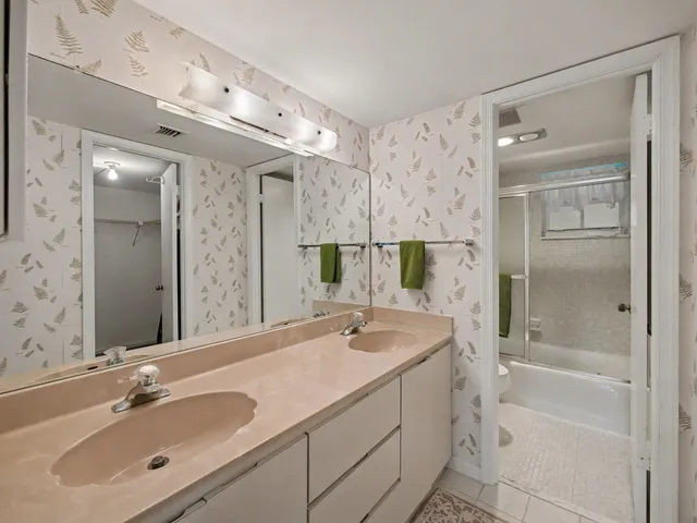a bathroom with a shower sink vanity granite and mirror