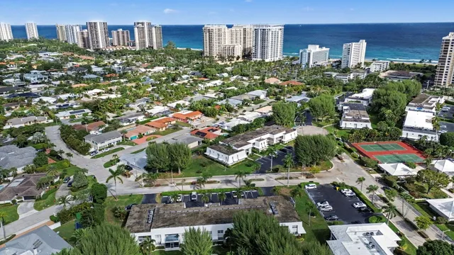 an aerial view of a house with a yard and lake view