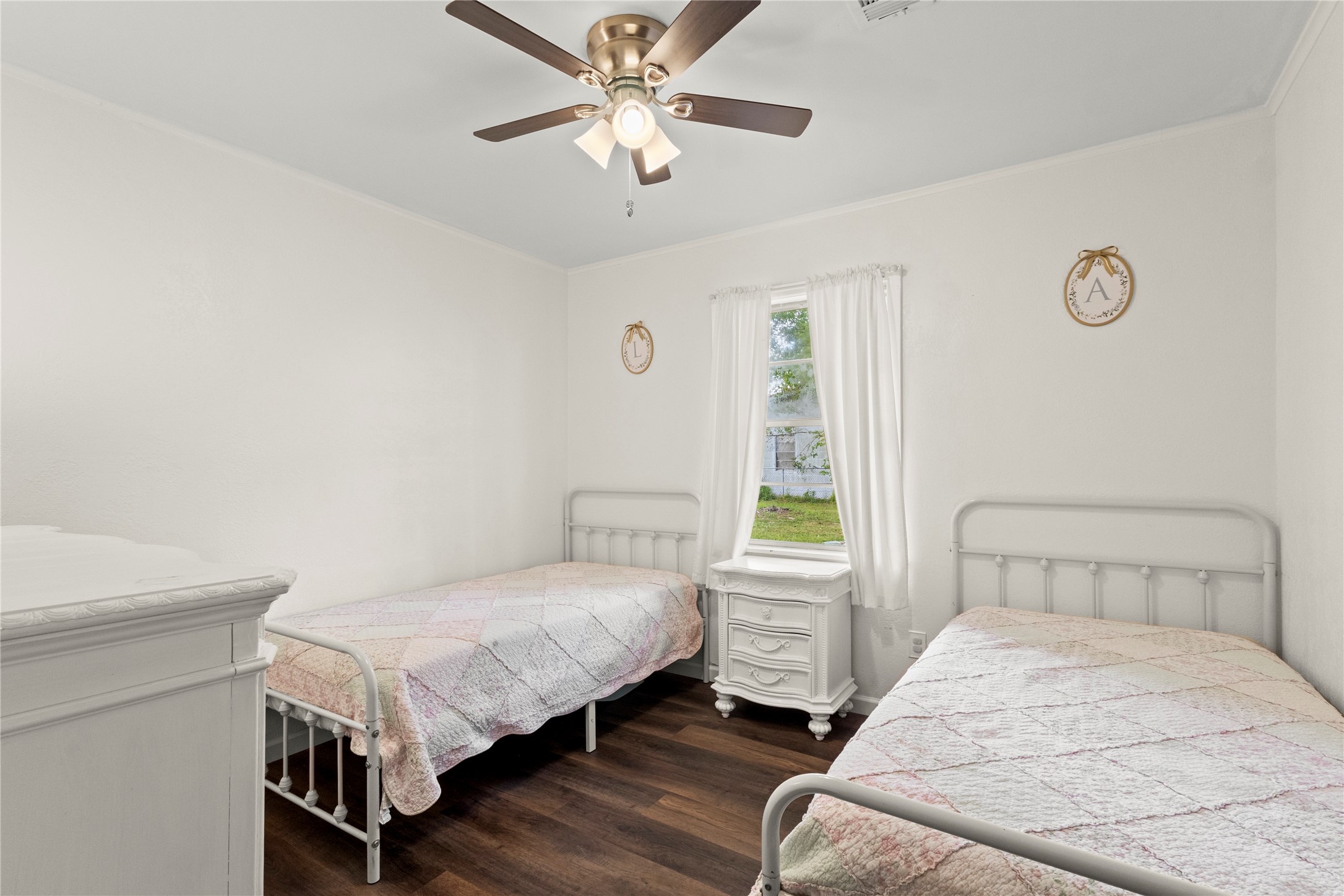 19961 Englin Road Winnie, TX 77665 - Photo 23 of 26 a bedroom with a bed and a chandelier