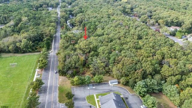 an aerial view of a house with a yard and lake view