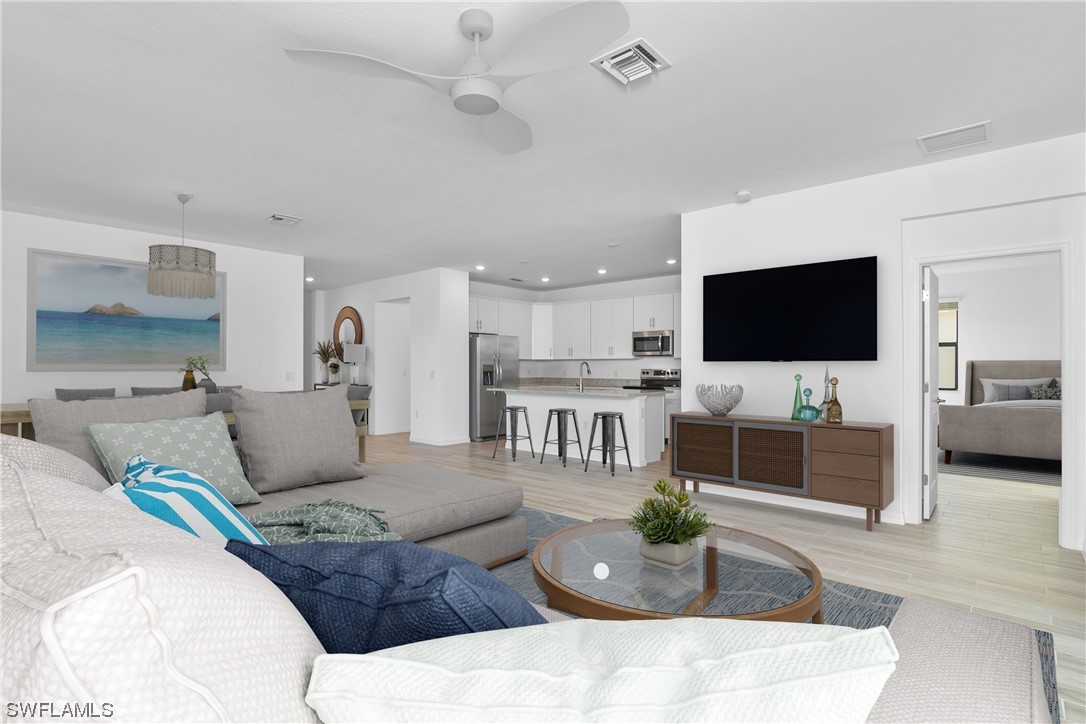 1395 Birdie Drive Naples, FL 34120 - Photo 1 of 17 a living room with furniture and a flat screen tv