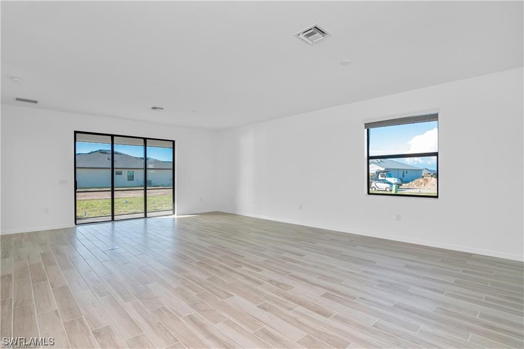 1395 Birdie Drive Naples, FL 34120 - Photo 17 of 17 a view of an empty room with wooden floor and a window