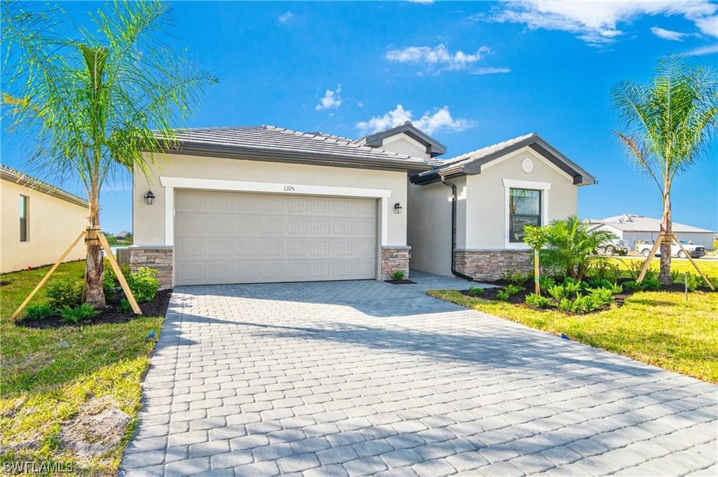 1395 Birdie Drive Naples, FL 34120 - Photo 4 of 17 a view of a house with a yard and potted plants