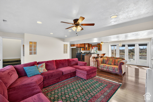 4768 East Hickman Canyon Road Stockton, UT 84071 - Photo 40 of 85 Basement living room featuring a ceiling fan, wood-style flooring, recessed lighting french walk out doors and a full kitchen.