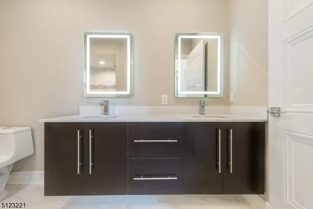 a bathroom with a sink vanity and mirror
