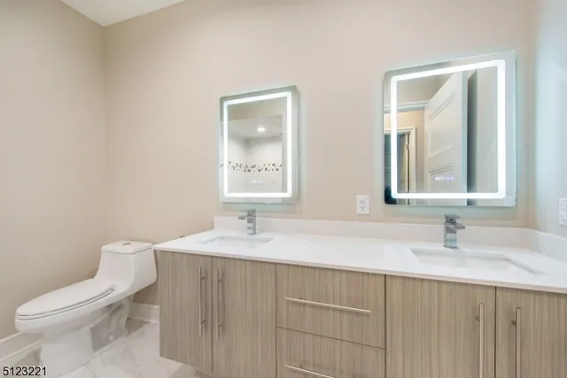 a bathroom with a sink toilet and mirror