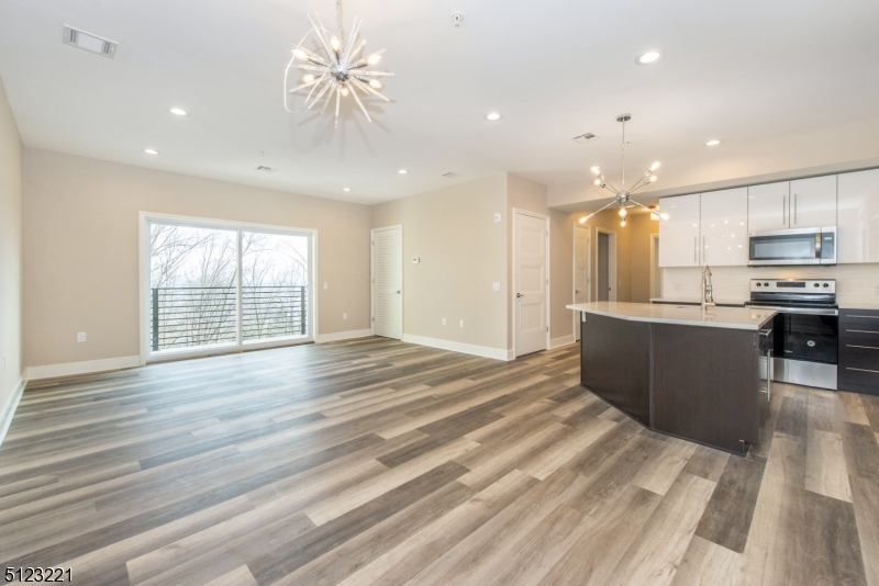 717 Preakness Avenue Wayne, NJ 07470 - Photo 3 of 19 a view of kitchen with kitchen island wooden floors appliances and cabinets