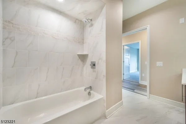 a bathroom with a bathtub and shower