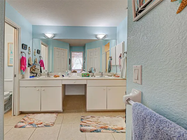 a bathroom with a sink mirror vanity and toilet