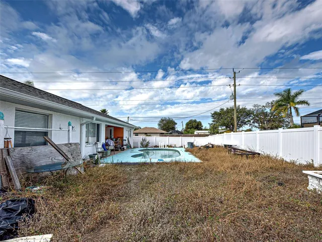 a view of a house with backyard and sitting area
